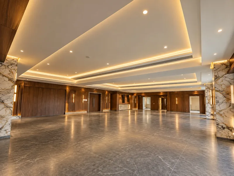 Banquet hall interior with lit ceiling at Amāra Hotel, Nizamabad