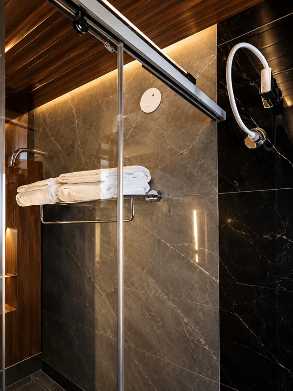 Glass-walled shower in a guest bathroom at Amāra Hotel